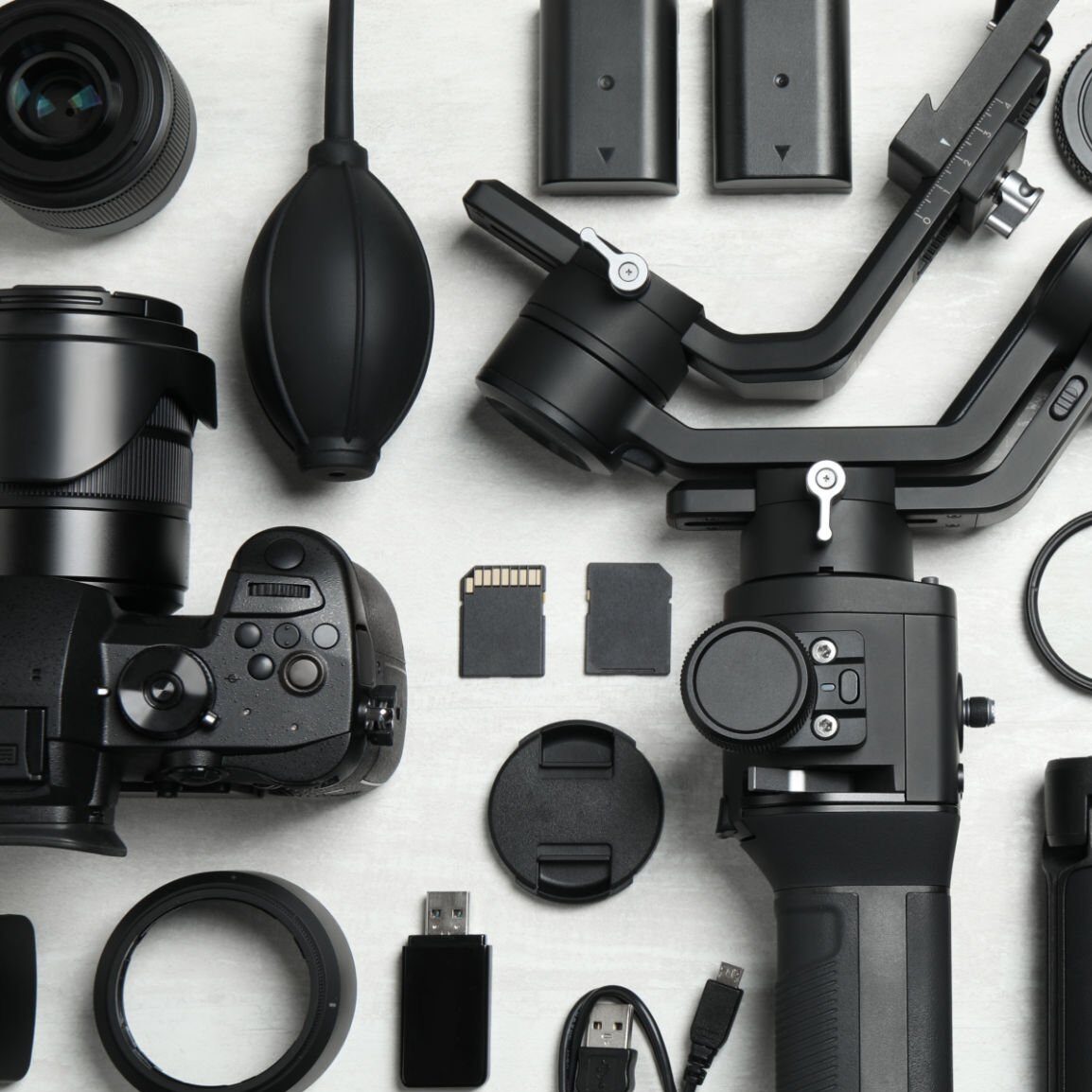 Camera and video production equipment on light background, flat lay. Space for text